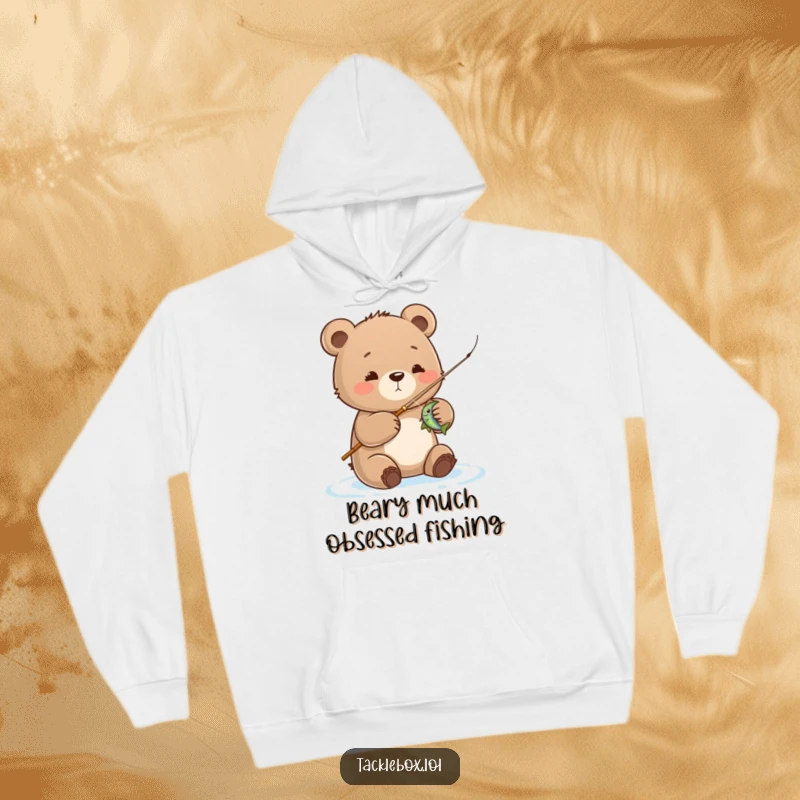 Funny bear cub hoodie, proudly reeling in a catch while fishing, embodying a cute and humorous outdoor adventure.