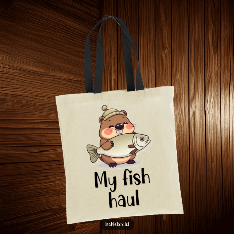Funny tote bag showing a giggling beaver in a tiny hat, proudly holding a large, shiny fish.